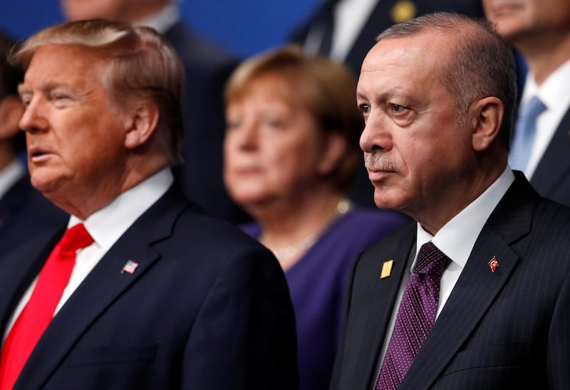 U.S. President Donald Trump and Turkey's President Tayyip Erdogan pose for a family photo during the annual NATO heads of government summit at the Grove Hotel in Watford, Britain December 4, 2019.  REUTERS/Peter Nicholls/Pool