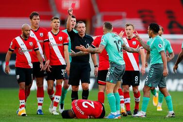 Everton's French defender Lucas Digne (3R) receives a red card from English referee Kevin Friend (C) for a foul on Southampton's English defender Kyle Walker-Peters (down) during the English Premier League football match between Southampton and Everton at St Mary's Stadium in Southampton, southern England, on October 25, 2020. RESTRICTED TO EDITORIAL USE. No use with unauthorized audio, video, data, fixture lists, club/league logos or 'live' services. Online in-match use limited to 120 images. An additional 40 images may be used in extra time. No video emulation. Social media in-match use limited to 120 images. An additional 40 images may be used in extra time. No use in betting publications, games or single club/league/player publications. / AFP / POOL / Frank Augstein / RESTRICTED TO EDITORIAL USE. No use with unauthorized audio, video, data, fixture lists, club/league logos or 'live' services. Online in-match use limited to 120 images. An additional 40 images may be used in extra time. No video emulation. Social media in-match use limited to 120 images. An additional 40 images may be used in extra time. No use in betting publications, games or single club/league/player publications.