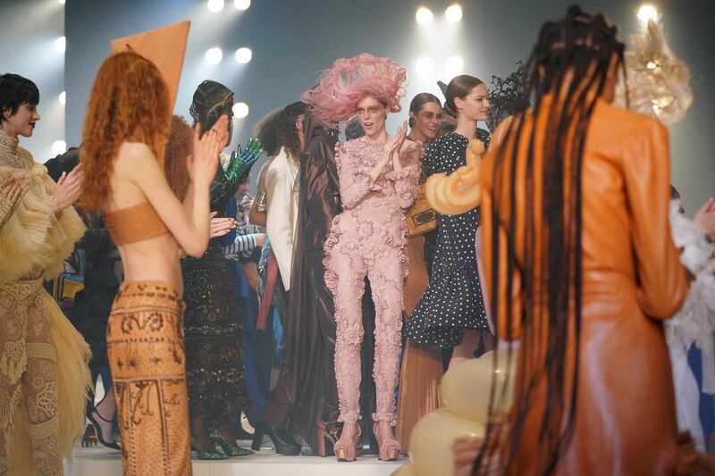 Coco Rocha, centre, and models are seen backstage after walking the runway at the Jean Paul Gaultier show at Theatre du Chatelet in Paris. Getty