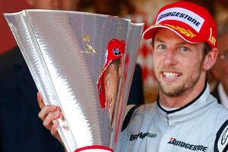 Brawn GP Formula One driver Jenson Button of Britain celebrates on the podium after winning the Monaco F1 Grand Prix in Monte Carlo May 24, 2009. Button won ahead of his team mate Rubens Barrichello of Brazil and Ferrari Formula One driver Kimi Raikkonen of Finland was third.    REUTERS/Max Rossi   (MONACO SPORT MOTOR RACING) *** Local Caption ***  MXR04000_MOTOR-RACI_0524_11.JPG