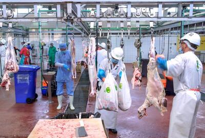 Butchers prepare cuts of meat for customers at the drive-through slaughterhouse in Mina Zayed. Victor Besa / The National 