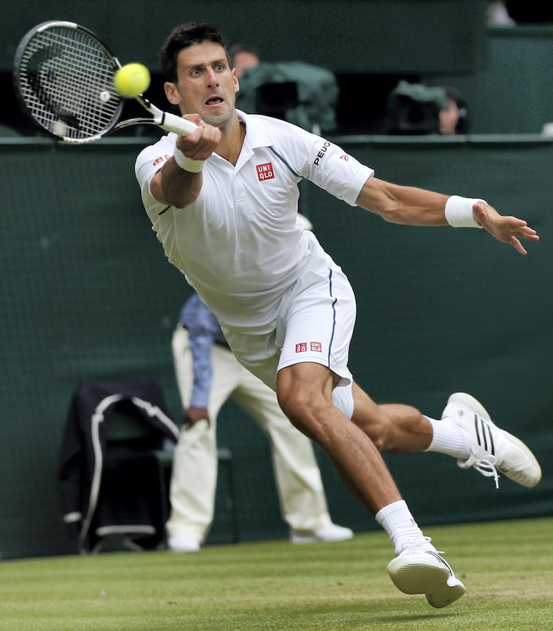 Serbia's Novak Djokovic returns to Switzerland's Roger Federer during their men's singles final match on day thirteen of the 2015 Wimbledon Championships at The All England Tennis Club in Wimbledon, southwest London, on July 12, 2015.  RESTRICTED TO EDITORIAL USE  --  AFP PHOTO / ADRIAN DENNIS (Photo by ADRIAN DENNIS / AFP)