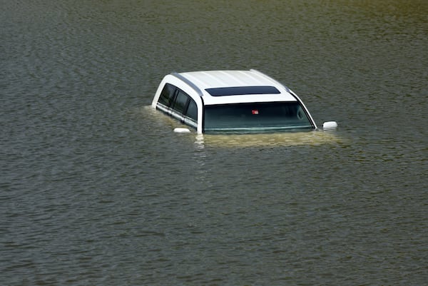 An abandoned vehicle lies in floodwater in Dubai, UAE. Getty Images