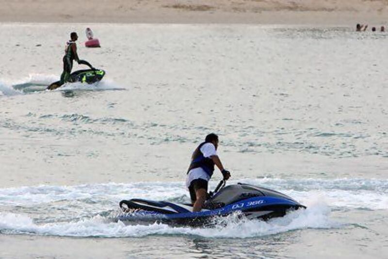 Jet skis have been controversial with swimmers near the beaches, but the new buoys system will help to keep both groups apart. Pawan Singh / The National