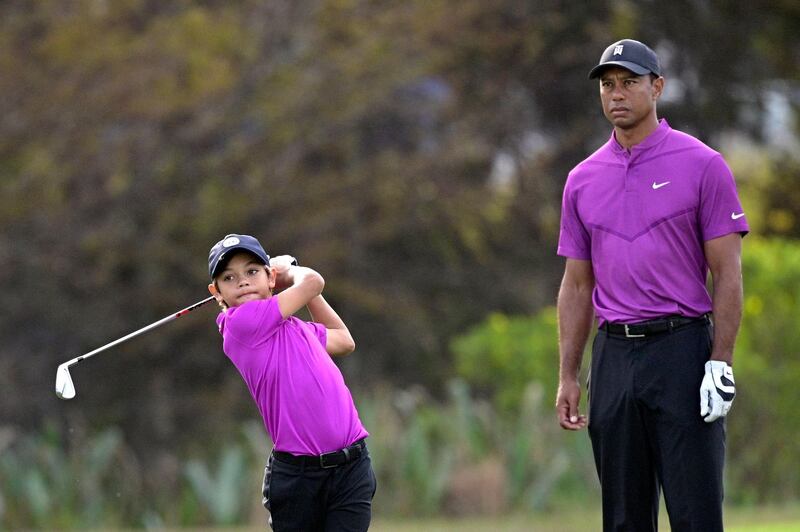 Tiger Woods watches Charlie hit from the 15th fairway. AP