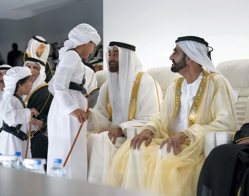 ABU DHABI, UNITED ARAB EMIRATES - December 02, 2018: HH Sheikh Mohamed bin Rashid Al Maktoum, Vice-President, Prime Minister of the UAE, Ruler of Dubai and Minister of Defence (R) and HH Sheikh Mohamed bin Zayed Al Nahyan, Crown Prince of Abu Dhabi and Deputy Supreme Commander of the UAE Armed Forces (2nd R), speak with HH Sheikh Tahnoon bin Mohamed bin Tahnoon Al Nahyan (2nd L) and HH Sheikh Zayed bin Mohamed bin Tahnoon Al Nahyan (L) , during the 47th UAE National Day celebrations, at Zayed Sports City.

( Mohamed Al Hammadi / Ministry of Presidential Affairs )
---