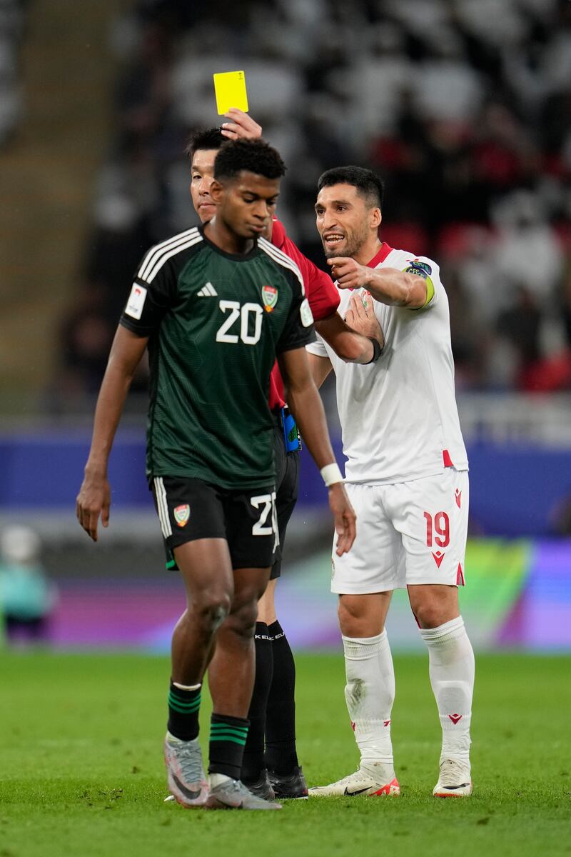 The UAE's Yahya Al Ghassani receives a yellow card for a foul. AP 