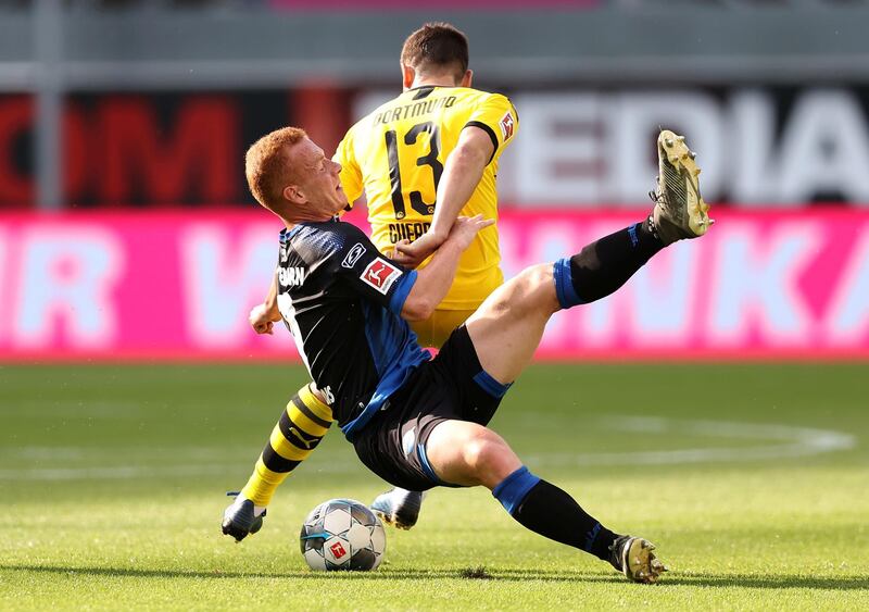 SC Paderborn's Sebastian Vasiliadis takes on Borussia Dortmund's Raphael Guerreiro. Reuters