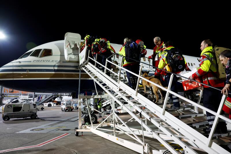 Members of International Search and Rescue Germany board a charter plane at Cologne-Bonn Airport on their way to help find survivors of the earthquake in Turkey. Reuters