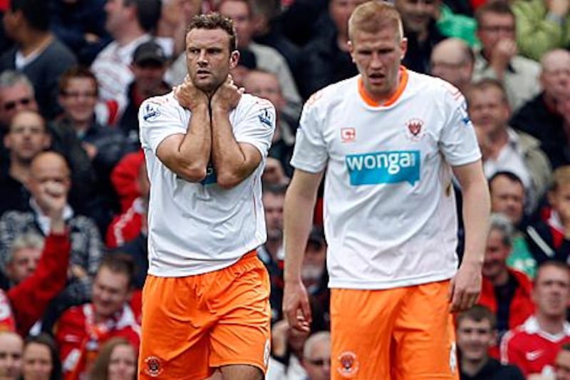 Ian Evatt, the Blackpool defender, left, reacts after scoring an own-goal which gave Manchester United a 3-2 lead. United scored once more to confirm the Seasiders' relegation from the Premier League.