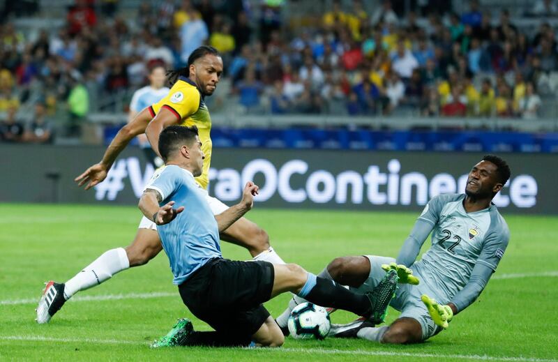 Ecuador's Alexander Dominguez, right, and Uruguay's Luis Suarez, compete for the ball during a Copa America Group C soccer match at the Mineirao stadium in Belo Horizonte, Brazil.  AP