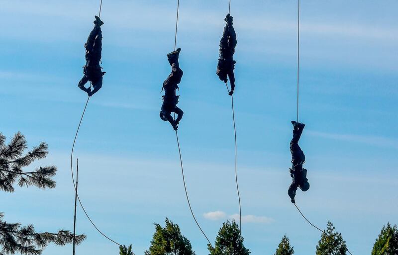 Members of Macedonian special police forces rappel from an helicopter as they take part in an emergency drill in Skopje, North Macedonia. AFP