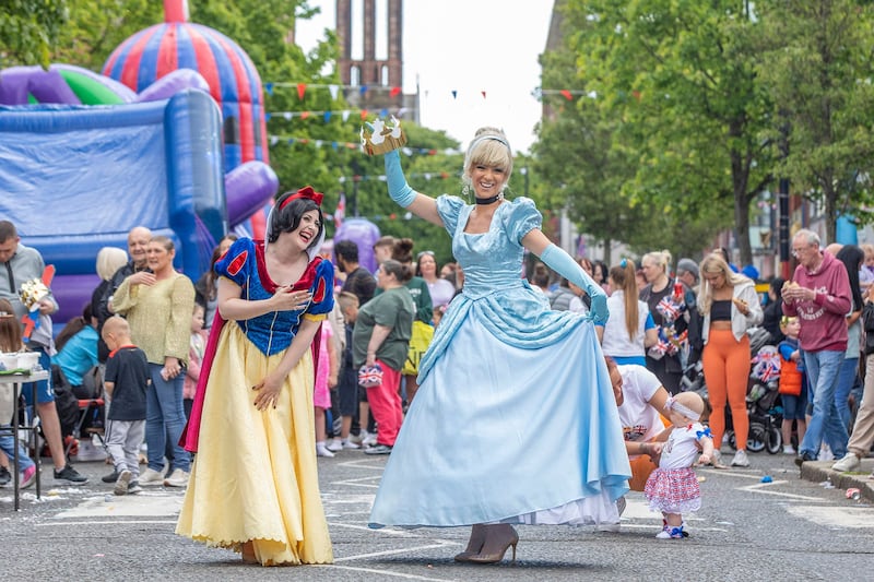 Two women dressed as Snow White and Cinderella take part in a parade in Belfast to celebrate Queen Elizabeth's platinum jubilee. AFP