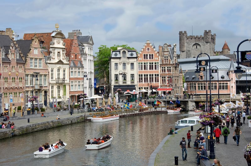 Everyday scene along the Graslei bank, lined with Baroque style Flemish gabled houses, Gravensteen Castle beyond, in the centre of Ghent, Belgium, Europe (Corbis)