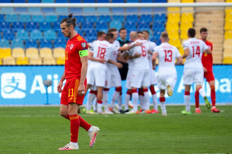 Belarus' players celebrate their first goal with Gareth Bale in the foreground. AFP