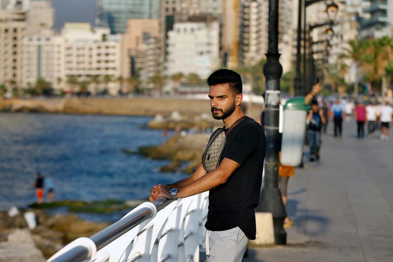 Lebanese Ali Mallah, 27, who recently lost his job as a salesman at a shoe store, stands on Beirut's waterfront promenade on the Mediterranean Sea. AP