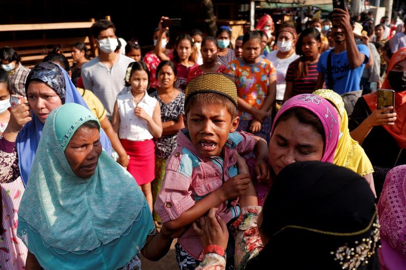 People attend the funeral of a woman who was shot dead yesterday while police were trying to disperse an anti-coup demonstration in Mandalay, Myanmar. Reuters