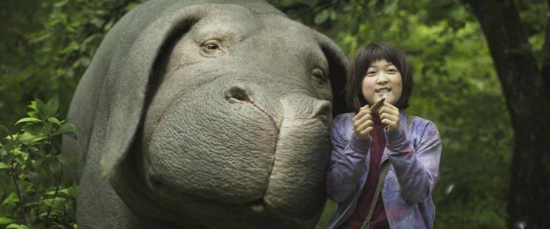 Ahn Seo-hyun as Mija with her gigantic pet and best friend in director Bong Joon-ho’s film Okja – the film attracted attention during its premiere in Cannes in May for all the wrong reasons. Netflix via AP Photo