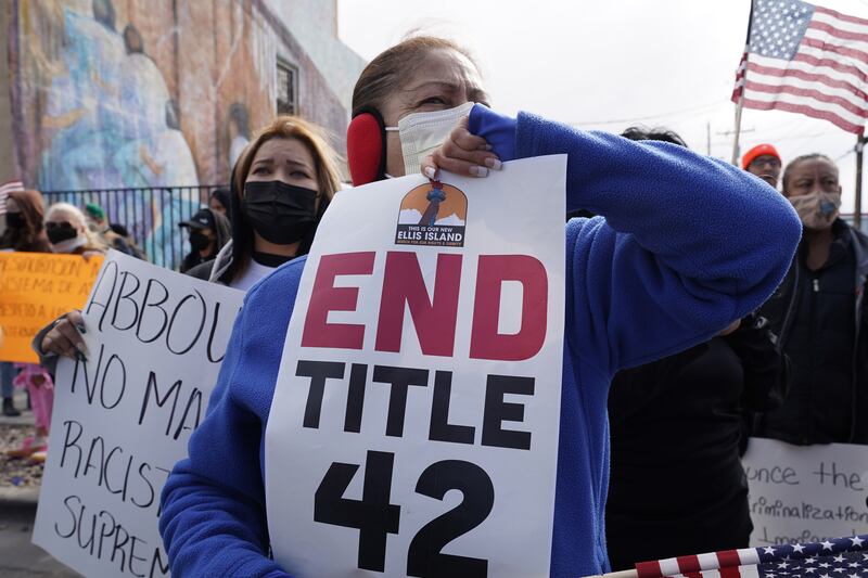 A woman holds a sign calling for an end to to Title 42, a policy the Biden administration has been using to turn migrants away. Willy Lowry / The National
