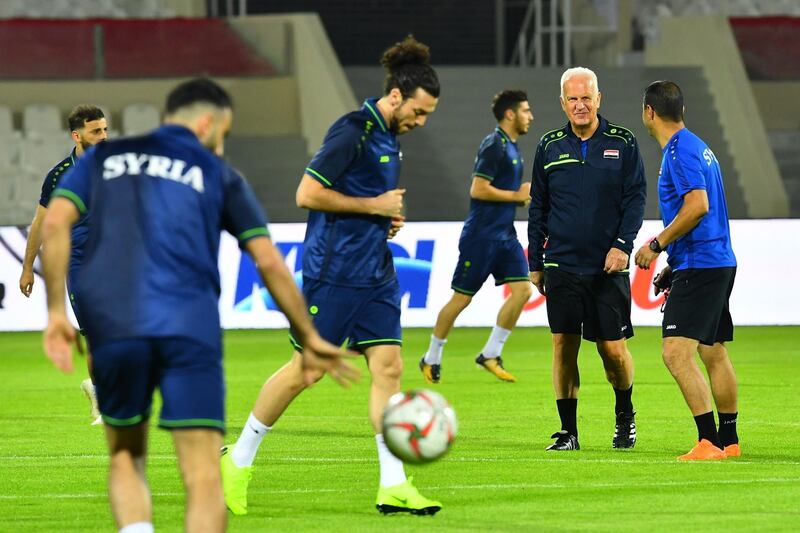 Syria's German coach Bernd Stange, second right, attends a training session with his players at Sharjah Stadium. AFP