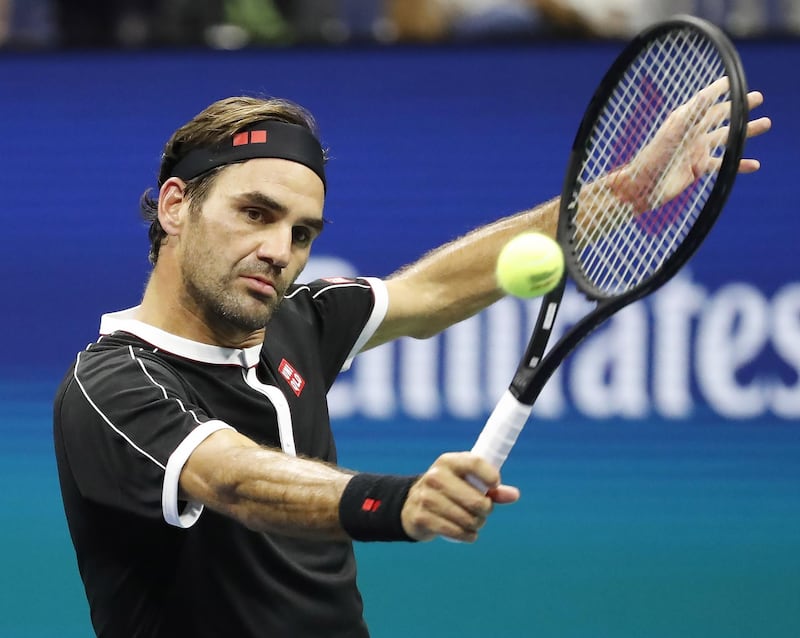 Roger Federer of Switzerland hits a return to Sumit Nagal . EPA