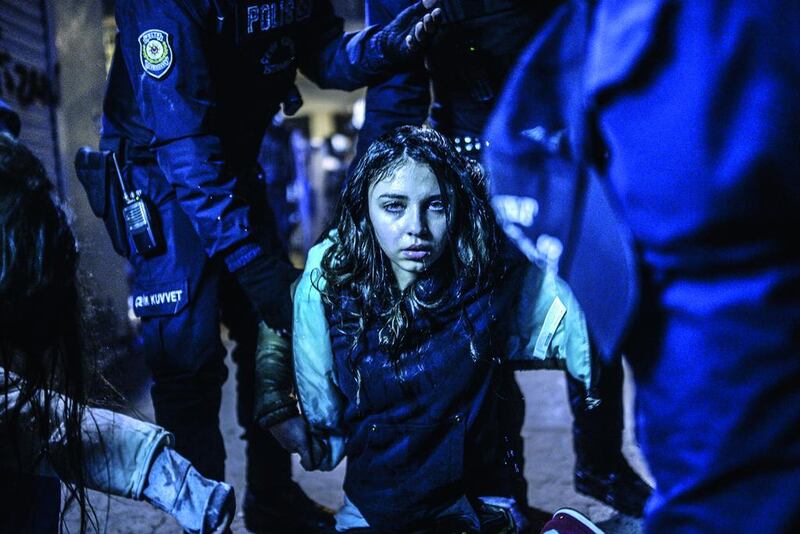 A young girl is pictured after she was wounded during clashes between riot police and prostestors after the funeral of Berkin Elvan, the 15-year-old boy who died from injuries suffered during last year’s anti-government protests in Istanbul on March 12. Riot police fired tear gas and water cannon at protestors in the capital Ankara, while in Istbanbul, crowds shouting anti-government slogans lit a huge fire as they made their way to a cemetery for the burial of Berkin Elvan.  Bulent Kilic / AFP