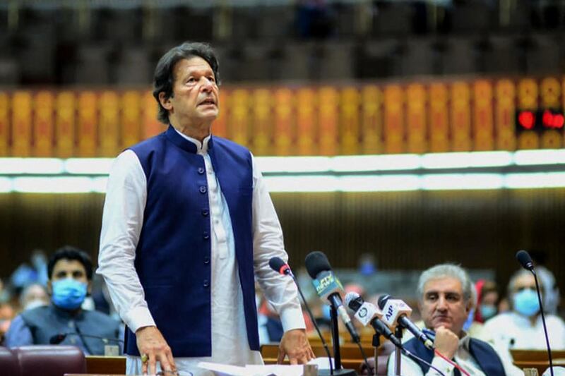 In this handout photograph released by the Pakistan's Press Information Department (PID) and taken on June 25, 2020, Pakistan's Prime Minister Imran Khan (L) speaks during the National Assembly session in Islamabad. - Pakistan's Prime Minister Imran Khan faced a growing backlash on June 25 after he said former Al-Qaeda leader Osama bin Laden had been "martyred".  (Photo by Handout / PID / AFP) / RESTRICTED TO EDITORIAL USE - MANDATORY CREDIT "AFP PHOTO / Pakistan's Press Information Department (PID)" - NO MARKETING - NO ADVERTISING CAMPAIGNS - DISTRIBUTED AS A SERVICE TO CLIENTS