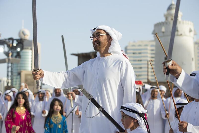 Sheikh Mohammed bin Zayed dances inside the grounds of Qasr Al Hosn fort. Seen with Sheikh Tahnoon bin Mohammed bin Tahnoon Al Nahyan. Ryan Carter / Crown Prince Court - Abu Dhabi 