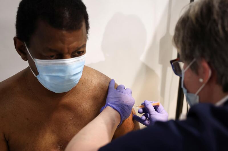 A person receives the vaccine in Westfield Stratford City shopping centre, London. Reuters