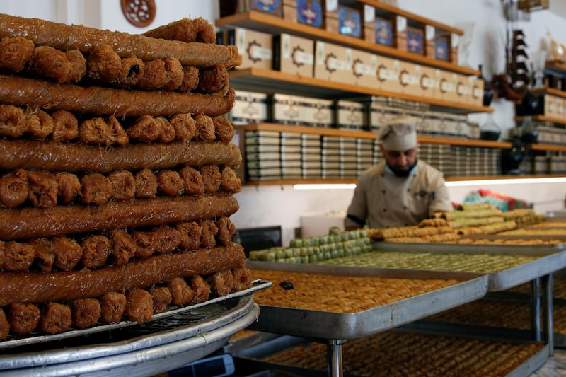 An Iraqi worker sorts trays of sweets during the last days of Ramadan at a shop in Baghdad. Reuters