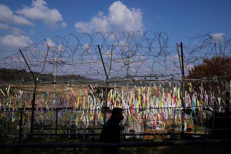 A wire fence decorated with ribbons with messages wishing for the reunification of the two Koreas at the Imjingak Pavilion in Paju, South Korea. October 28, 2022. AP Photo