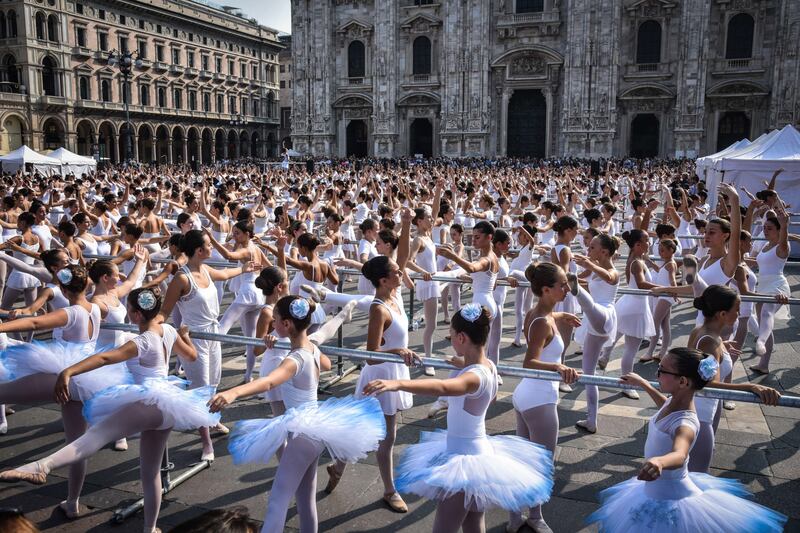Italian ballet dancer Roberto Bolle (unseen) dances with 1,500 students of dance schools at Piazza Duomo at the  OnDance dance festival, in Milan, Italy. EPA