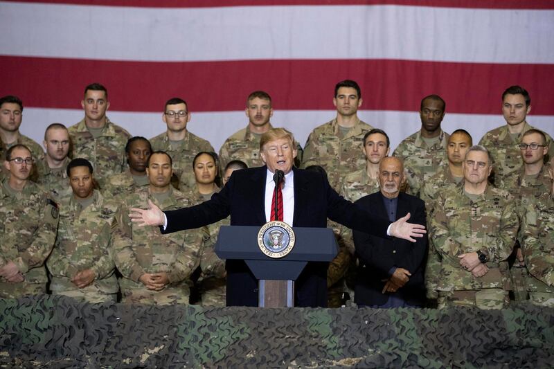 President Donald Trump with Afghan President Ashraf Ghani and Joint Chiefs Chairman Gen Mark Milley addresses members of the military during a surprise Thanksgiving Day visit at Bagram Air Field, Afghanistan. AP