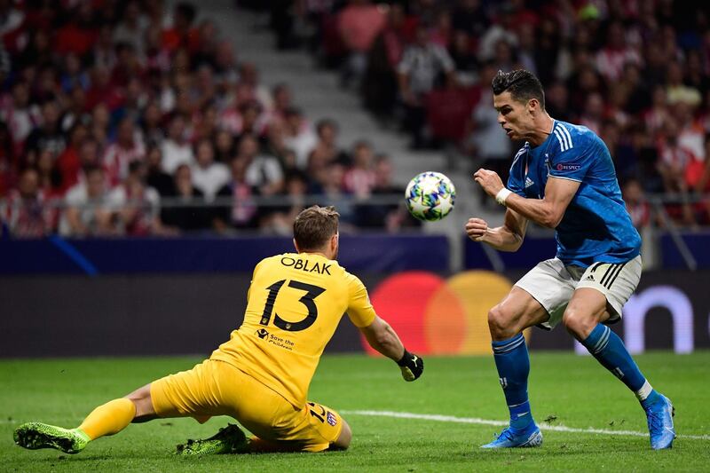 Juventus' Portuguese forward Cristiano Ronaldo challenges Atletico Madrid's Slovenian goalkeeper Jan Oblak. AFP