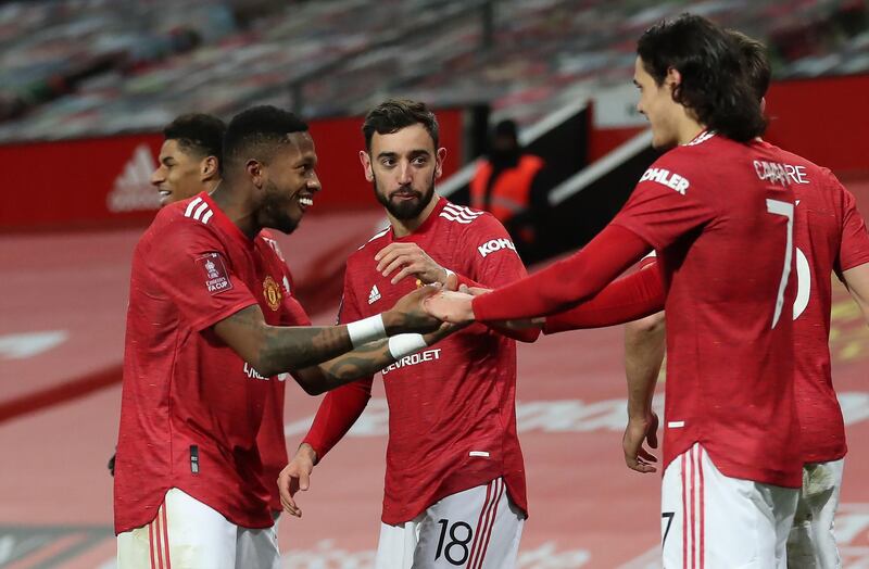 Manchester United's Bruno Fernandes (centre) celebrates with his team-mates after scoring his side's third goal of the game during the Emirates FA Cup fourth round match at Old Trafford, Manchester. Picture date: Sunday January 24, 2021. PA Photo. See PA story SOCCER Man Utd. Photo credit should read: Martin Rickett/PA Wire. RESTRICTIONS: EDITORIAL USE ONLY No use with unauthorised audio, video, data, fixture lists, club/league logos or "live" services. Online in-match use limited to 120 images, no video emulation. No use in betting, games or single club/league/player publications.