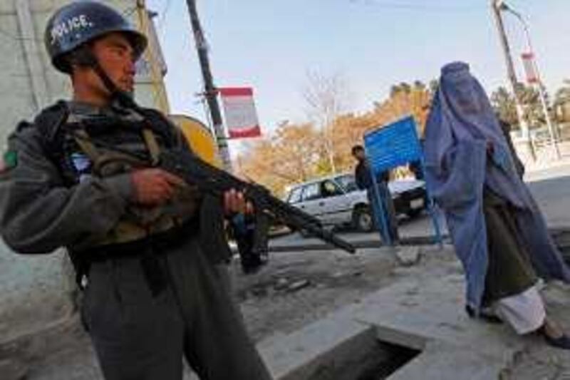 An Afghan policeman stands guard near the street where a Western aid worker was kidnapped on November 3, 2008. Unidentified gunmen abducted a Western aid worker in a street in the Afghan capital and shot dead an Afghan who tried to rescue him, the government said. The man was walking in a suburb of Kabul when he was snatched by three armed men, interior ministry spokesman Zemarai Bashari told AFP.  AFP PHOTO /Massoud HOSSAINI