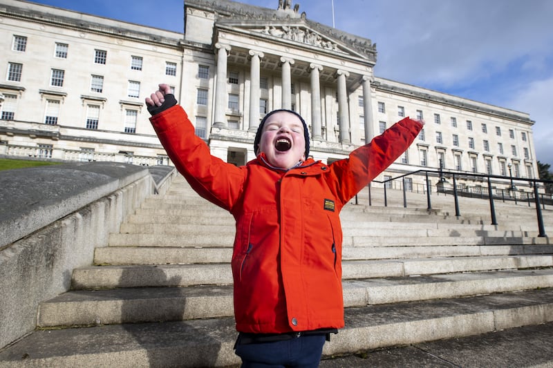 Young organ-donation campaigner Daithi MacGabhann, 6, outside the seat of Northern Ireland's government in Belfast. The region's post-Troubles achievements are a positive example to other societies with deep and sometimes divisive histories. PA