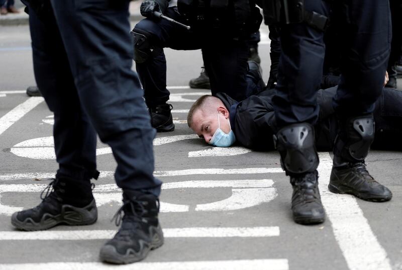 Riot police officers detain a demonstrator during a protest against the Czech government's restrictions, as the spread of the coronavirus continues in Prague, Czech Republic. Reuters
