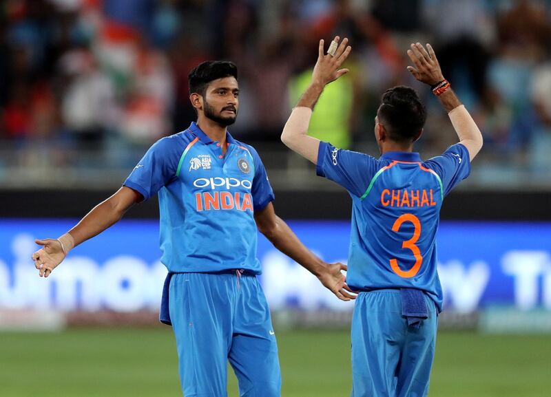 Dubai, United Arab Emirates - September 18, 2018: India's Khaleel Ahmed takes the wicket of Hong Kong's Ehsan Khan and celebrates with team mate Yuzvendra Chahal who also took 3 wickets during the game between India and Hong Kong in the Asia cup. Tuesday, September 18th, 2018 at Sports City, Dubai. Chris Whiteoak / The National