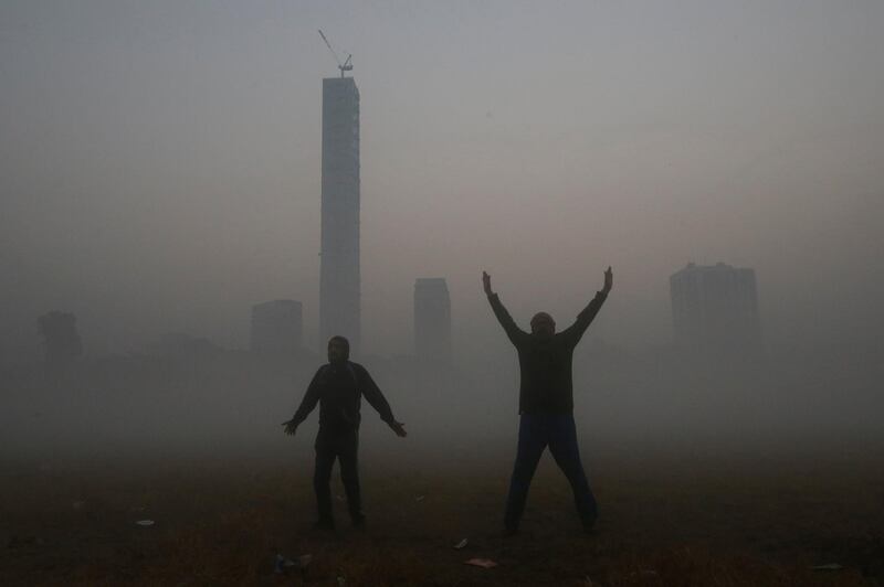 Men exercise inside a public park on a foggy winter morning in Kolkata, India. Reuters