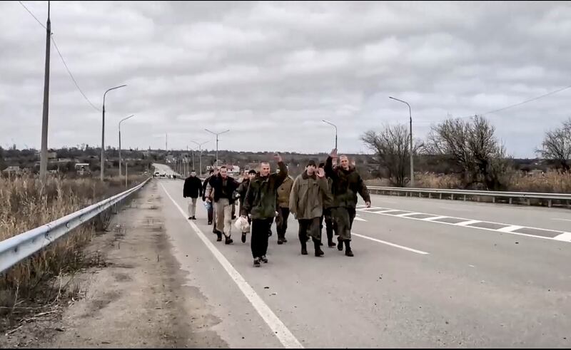 A group of Russian prisoners of war (POW) walk home after a prisoners swap with Ukraine. Russian Defence Ministry Press Service / EPA