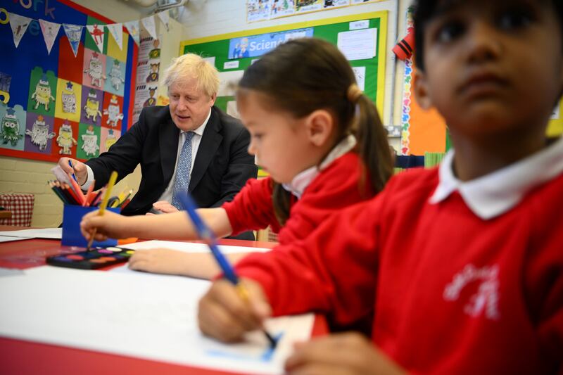 Prime Minister Boris Johnson paints with children during a visit to a school in South Ruislip on Friday, after the local government elections. PA