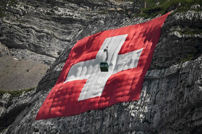 A 6,400 square-metre Swiss flag hangs on the rock face of mountain Saentis on the eve of the country's national day. AFP
