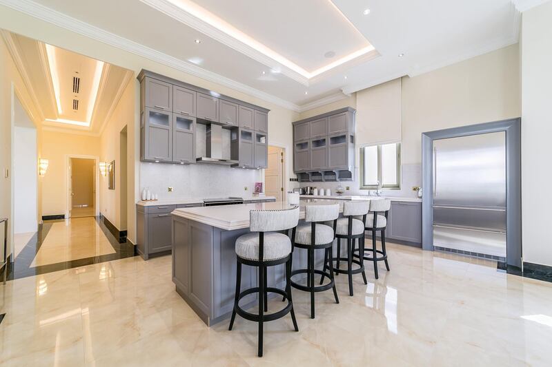 <p>A breakfast bar allows for less formal dining in the kitchen.&nbsp;Courtesy LuxuryProperty.com</p>
