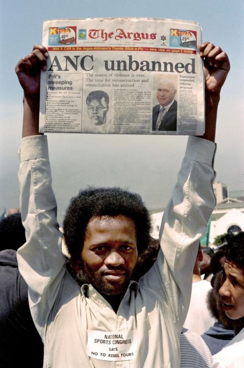 February 02, 1990: A young man holds a local newspaper in Cape Town announcing that ANC is unbanned, during a demonstration of anti-Apartheid marchers demanding the release of all the political prisoners in South Africa. AFP PHOTO