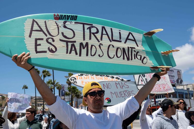 ‘Australia We Are With You’: Members of the surfing community protesting after two Australians and a US surfer went missing last week in the sea in Ensenada, Baja California state, Mexico. AFP