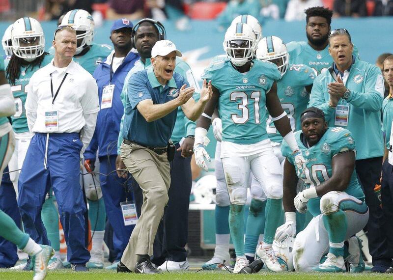 Miami Dolphins coach Joe Philbin, centre, shouts out during the NFL football game between the New York Jets and the Miami Dolphins and at Wembley stadium in London, Sunday, Oct. 4, 2015. (AP Photo/Matt Dunham)