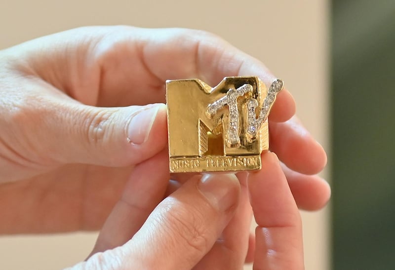 Fab 5 Freddy's gold and diamond 'MTV' ring is displayed during a press preview at Sotheby's for their Hip-Hop auction. AFP
