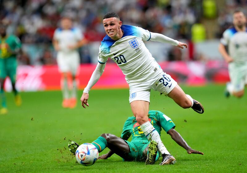 England's Phil Foden evades being tackled by Senegal's Youssouf Sabaly. PA