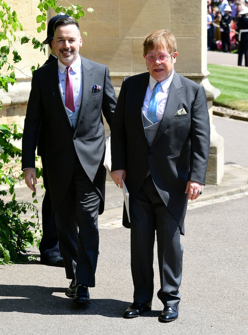 David Furnish and Elton John, wearing a morning suit with a grey waistcoat, leave St George's Chapel at Windsor Castle after the wedding of Meghan Markle and Prince Harry on May 19, 2018 in Windsor, England. Getty Images